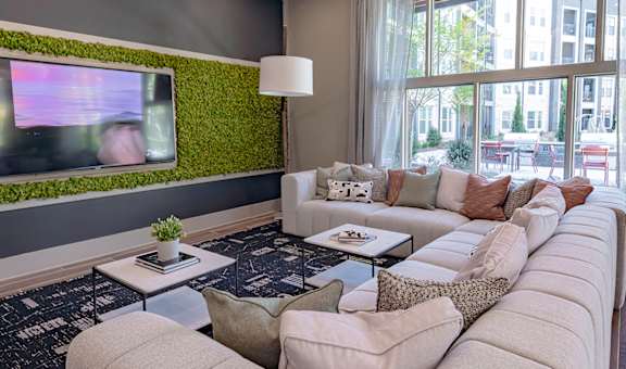 a living room filled with furniture and a large window