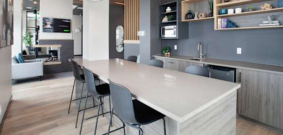 A modern kitchen with a large island and bar stools.