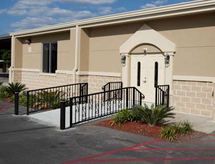 A building with a black gate and a yellow line on the ground at Willow Creek Apartments, Houston, TX
