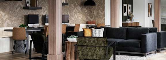 A modern living room with a black couch and a wooden floor at The SoHo Luxury Apartments, Raleigh, NC
