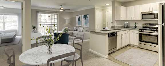 a kitchen with stainless steel appliances and white cabinets