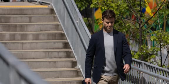 a man walking down stairs with a brief case