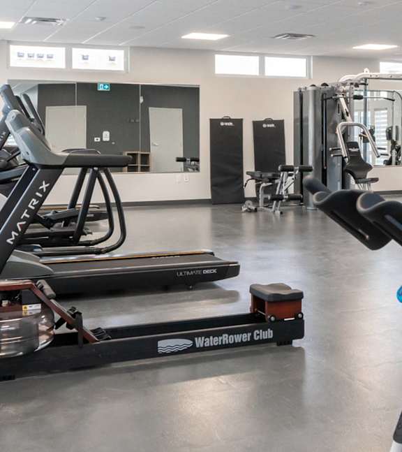A gym with treadmills and exercise equipment.at Latitude 49 Townhomes, Manitoba, R3X 0M1