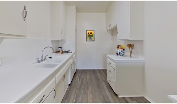 A small bathroom with a sink, toilet, and a cabinet.