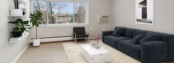 A living room with a grey couch and a white coffee table.