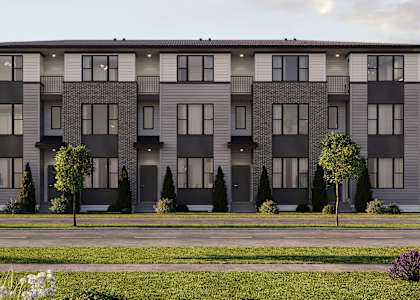 A modern apartment building with a grassy front yard.