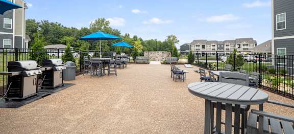 A sunny day at the outdoor seating area of a building at Aventura at Wentzville I & II Apartments, Missouri, 63385