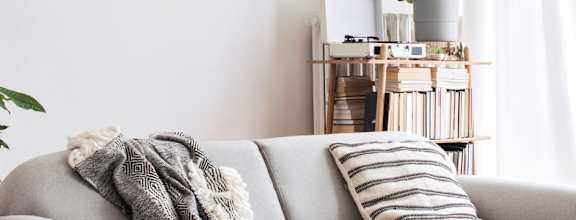 a living room with a couch and a painting on the wall