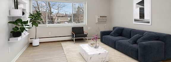 A living room with a grey couch and a white coffee table.