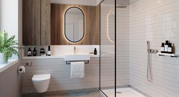 Modern en-suite bathroom with walk-in rainfall shower and fluted tile finishes.