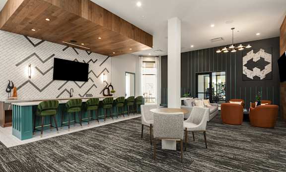 A modern lounge area with a bar and seating.