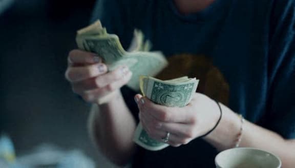 a woman holding money in her hands