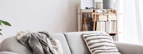a living room with a couch and a painting on the wall
