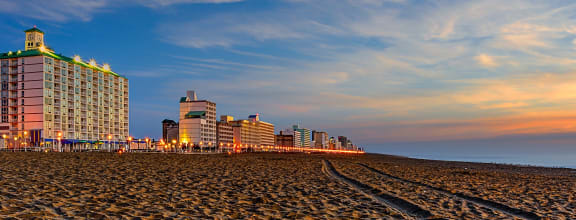 a view of the beach and hotels at sunset on the beach