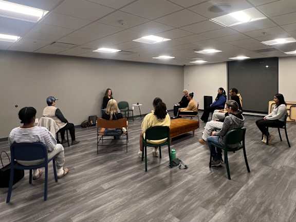 A group of people are sitting in a circle in a room at The Gallery Apartment Homes Apartments, Allentown, PA, 18101