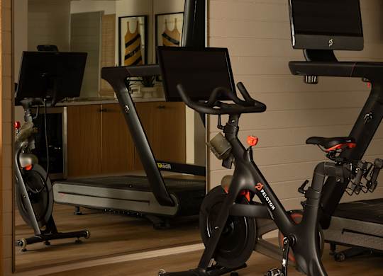 A room with a treadmill, a stationary bike and a computer monitor at The PARKER on E Mulberry Apartments, Texas