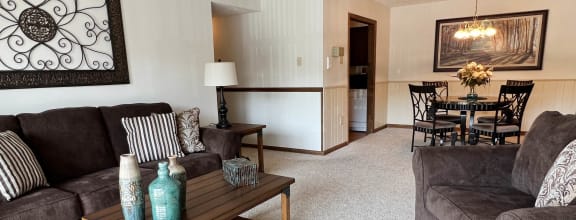 a living room with a couch and a table at Crestbrook Apartments & Townhomes, Crescent Spring, Kentucky