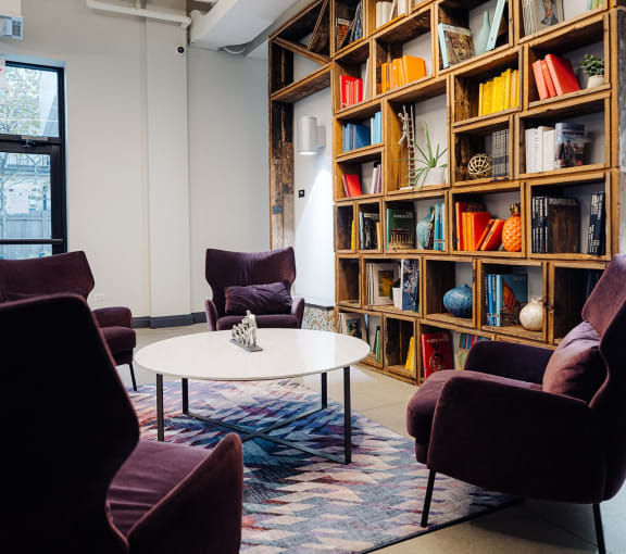 a living room with a view of a city and a table and chairs