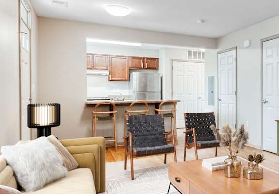 a living room with a couch coffee table and a tv on the wall at Niagara Square, Buffalo, 14201