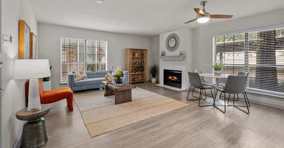 A modern living room with a fireplace and a dining area.