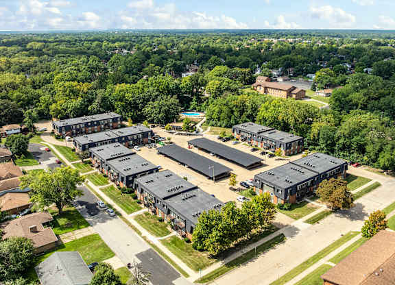 A bird's eye view of a suburban area with a large building complex in the center