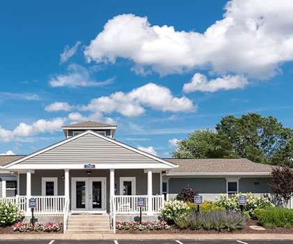 A building with a front porch and a sign that says "Achievement" on it.