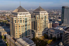 A cityscape with modern buildings and a clear sky.