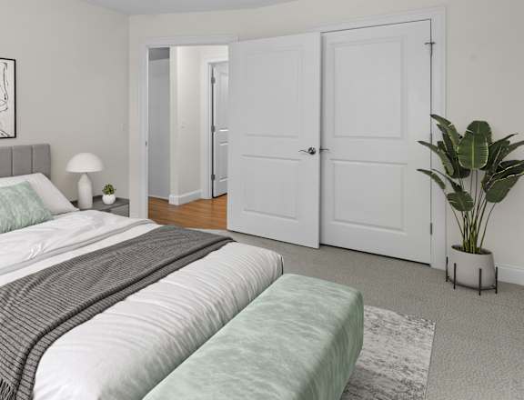 a white bedroom with a bed and a white closet