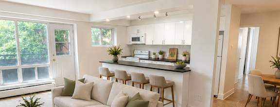 A modern dining room with a wooden table and chairs.