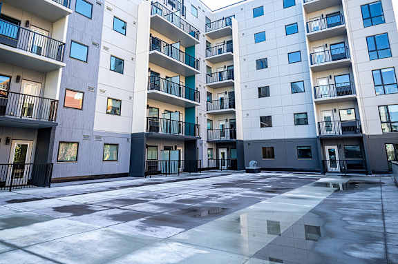 an empty street in front of an apartment building