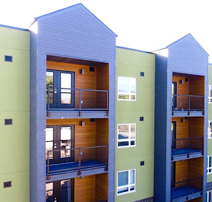 A row of modern apartment buildings with balconies.