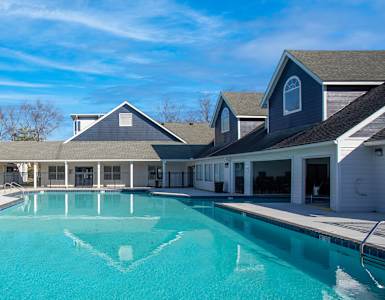 a swimming pool with a house in the background