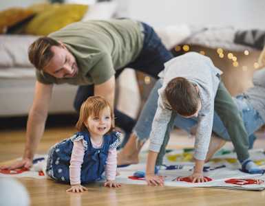 a family playing with a child on the floor