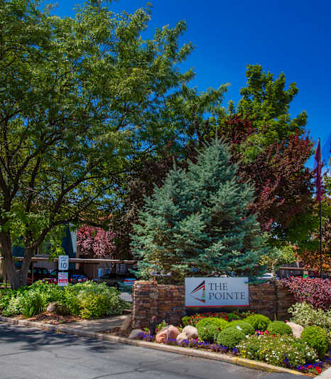The Pointe is a beautiful residential complex with a well-maintained garden in front.