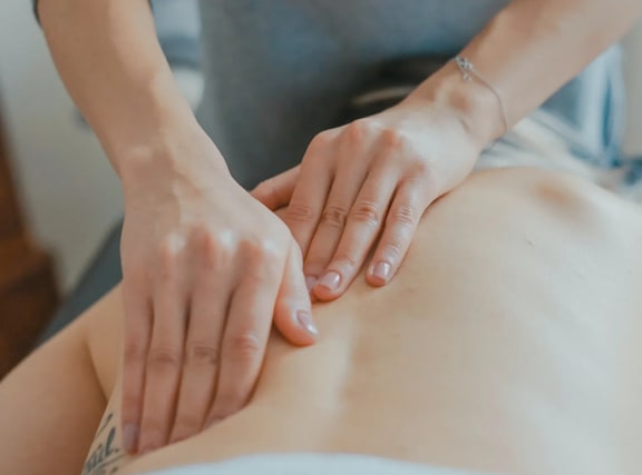 a woman is giving a patient a massage on her abdomen