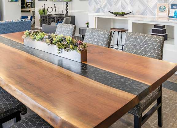 The community lounge at Parkside Commons with a long wooden table and chairs