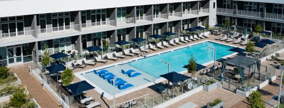 an aerial view of a large hotel with a swimming pool and lounge chairs at 20 Midtown, Birmingham, Alabama