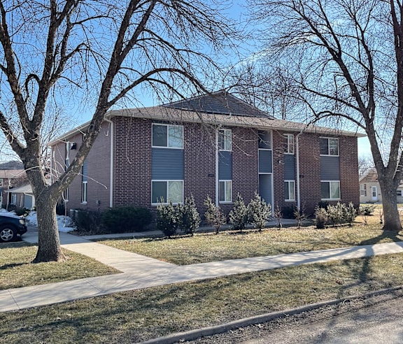 an apartment building with trees in front of it