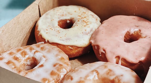 a box of donuts with frosting in a box