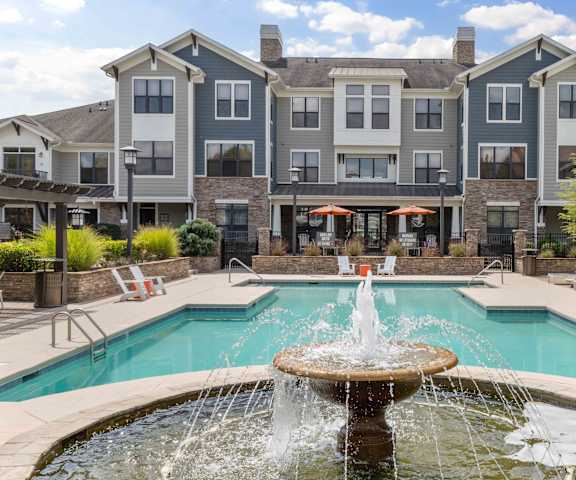 building exterior with fountain and swimming pool