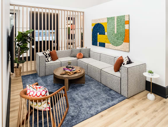 a living room with a couch and chairs and a rug