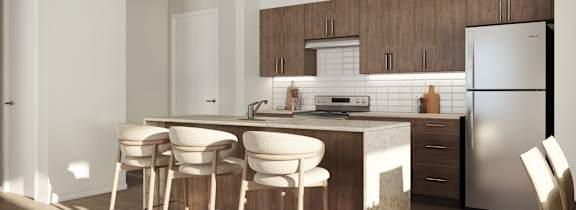 A kitchen with a bar area and a refrigerator.