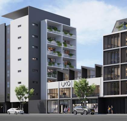 A modern building with a glass facade and a sign that reads "IKO".