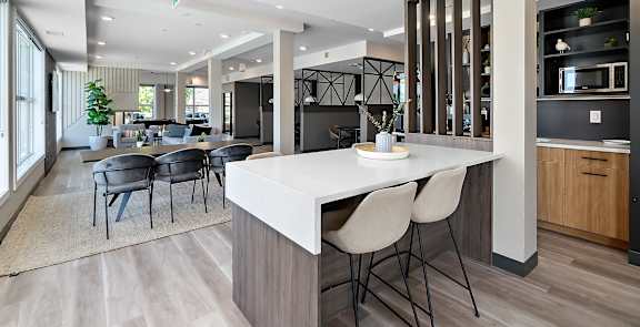A modern kitchen with a dining table and chairs.
