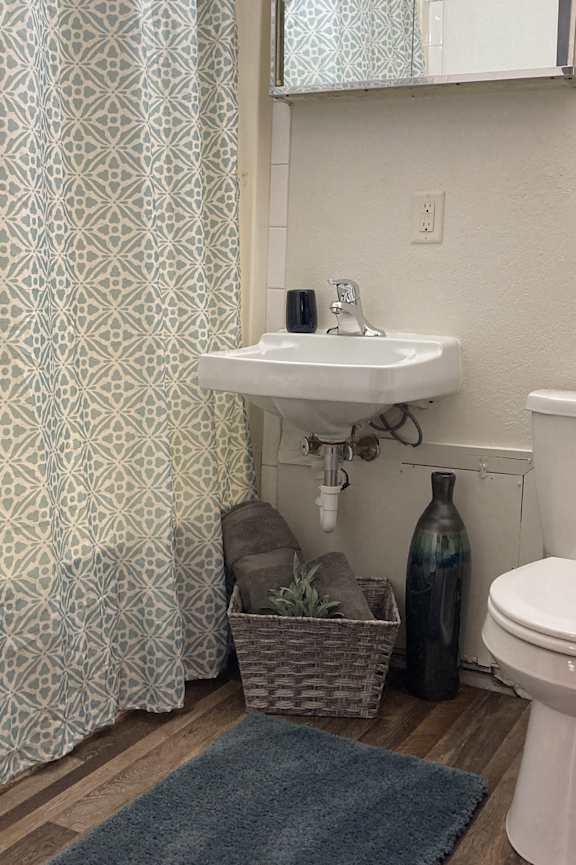 a bathroom with a toilet and a sink and a bath tub