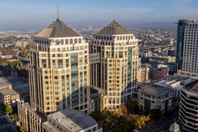 Oakland Ca cityscape with modern buildings and a clear sky.