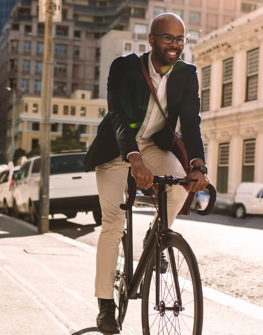 a man riding a bike on a city street