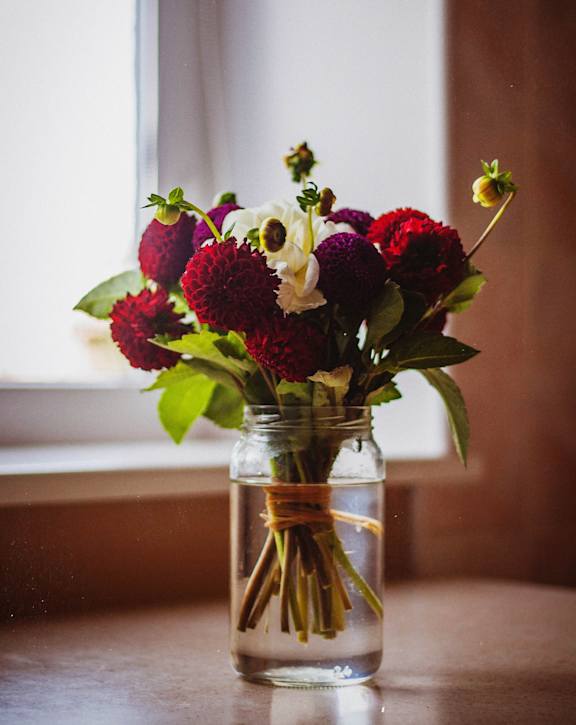 Bouquet of flowers in a jar displayed in a bright apartment at Appletree Apartments.