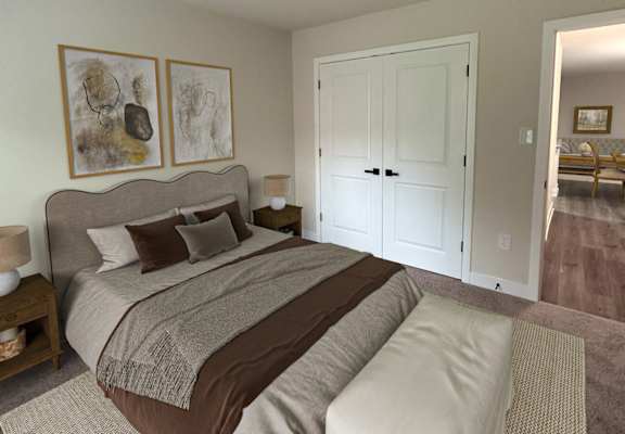 a bedroom with a bed and a door to a bathroom