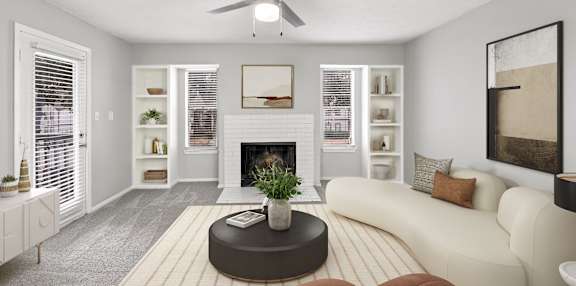 A living room with a fireplace, a couch, and a ceiling fan.